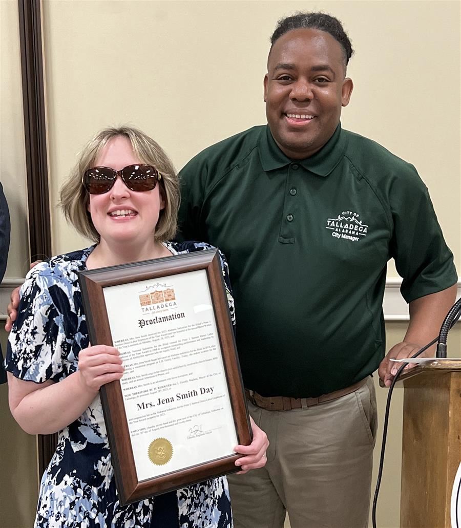  Jena Smith holds a resolution from Talladega while smiling to the camera with Sedrick Hill. 